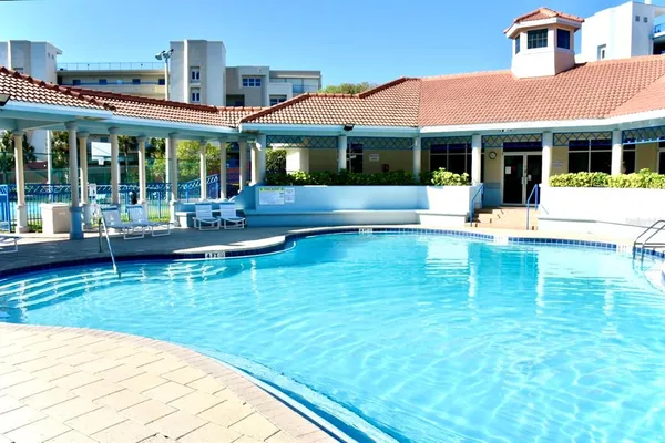a view of house with swimming pool outdoor seating