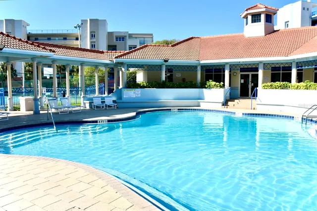 a view of house with swimming pool outdoor seating