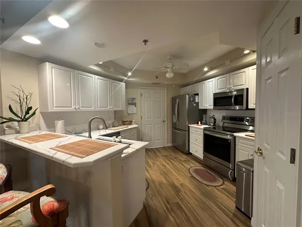 a kitchen with a sink appliances and cabinets