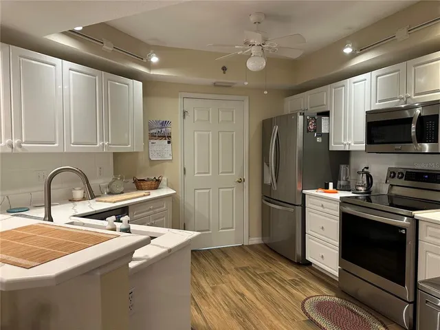 a kitchen with a sink appliances and cabinets
