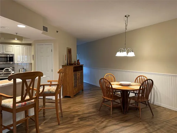 a view of a dining room with furniture and wooden floor
