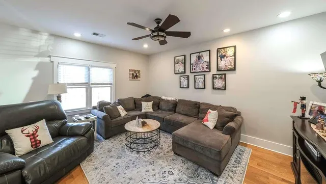 a kitchen with a chandelier and living room view