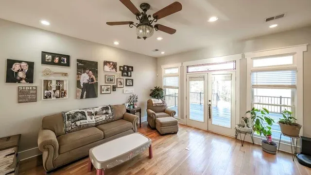 a view of a livingroom with a furniture hardwood floor and a ceiling fan