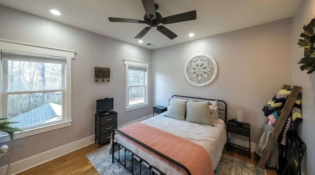 a bedroom with a bed and a large window