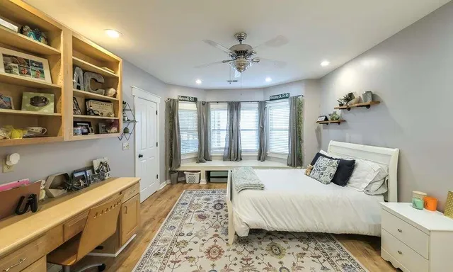 a spacious bathroom with a granite countertop tub sink and mirror