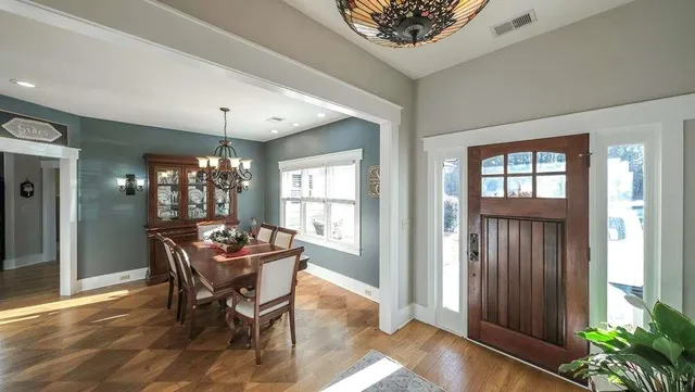 a living room with lots of furniture and view of kitchen