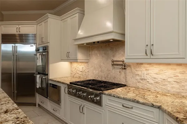 a stove top oven sitting inside of a kitchen