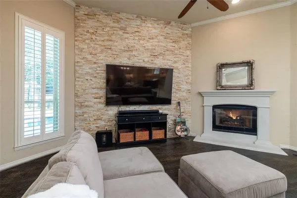 a living room with furniture a flat screen tv and a fireplace