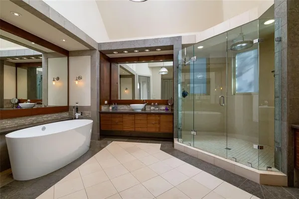 a bathroom with a large tub and shower