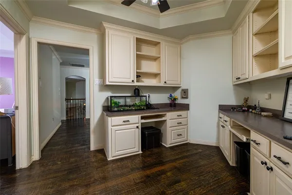 a kitchen with stainless steel appliances white cabinets and a stove top oven