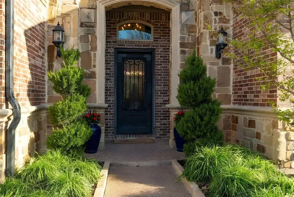 a red brick building with potted plants in front of it