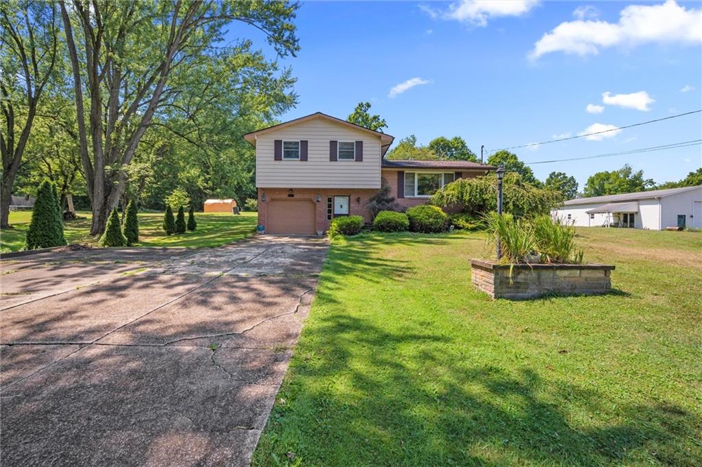 545 Bedford Road West Middlesex, PA 16159 - Photo 1 of 25 a front view of a house with garden