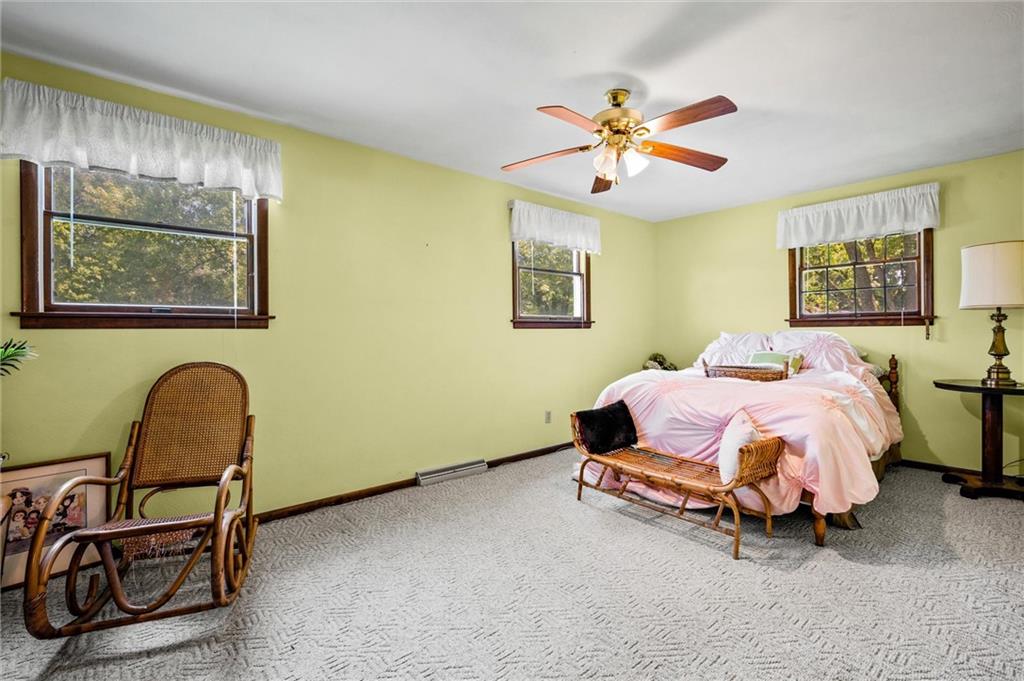 545 Bedford Road West Middlesex, PA 16159 - Photo 13 of 25 a spacious bedroom with a bed and chair