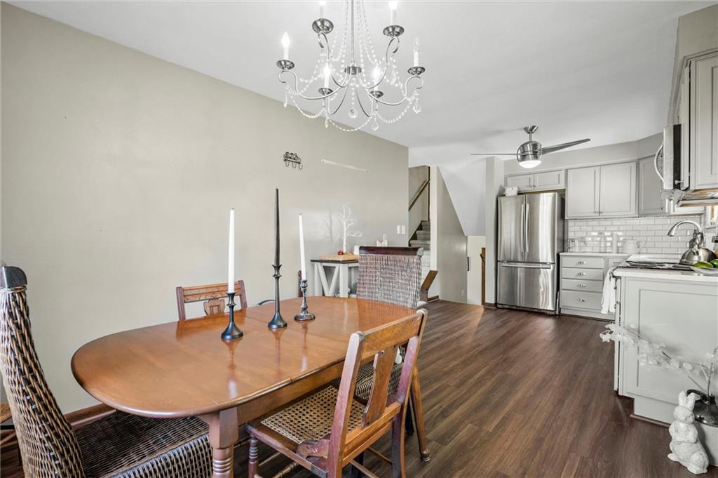 545 Bedford Road West Middlesex, PA 16159 - Photo 5 of 25 a dining room with wooden floor a chandelier a wooden table and chairs
