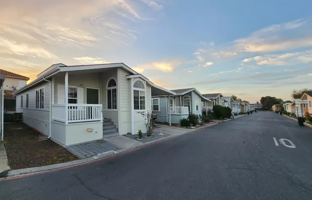 a front view of a house with a yard and seating space