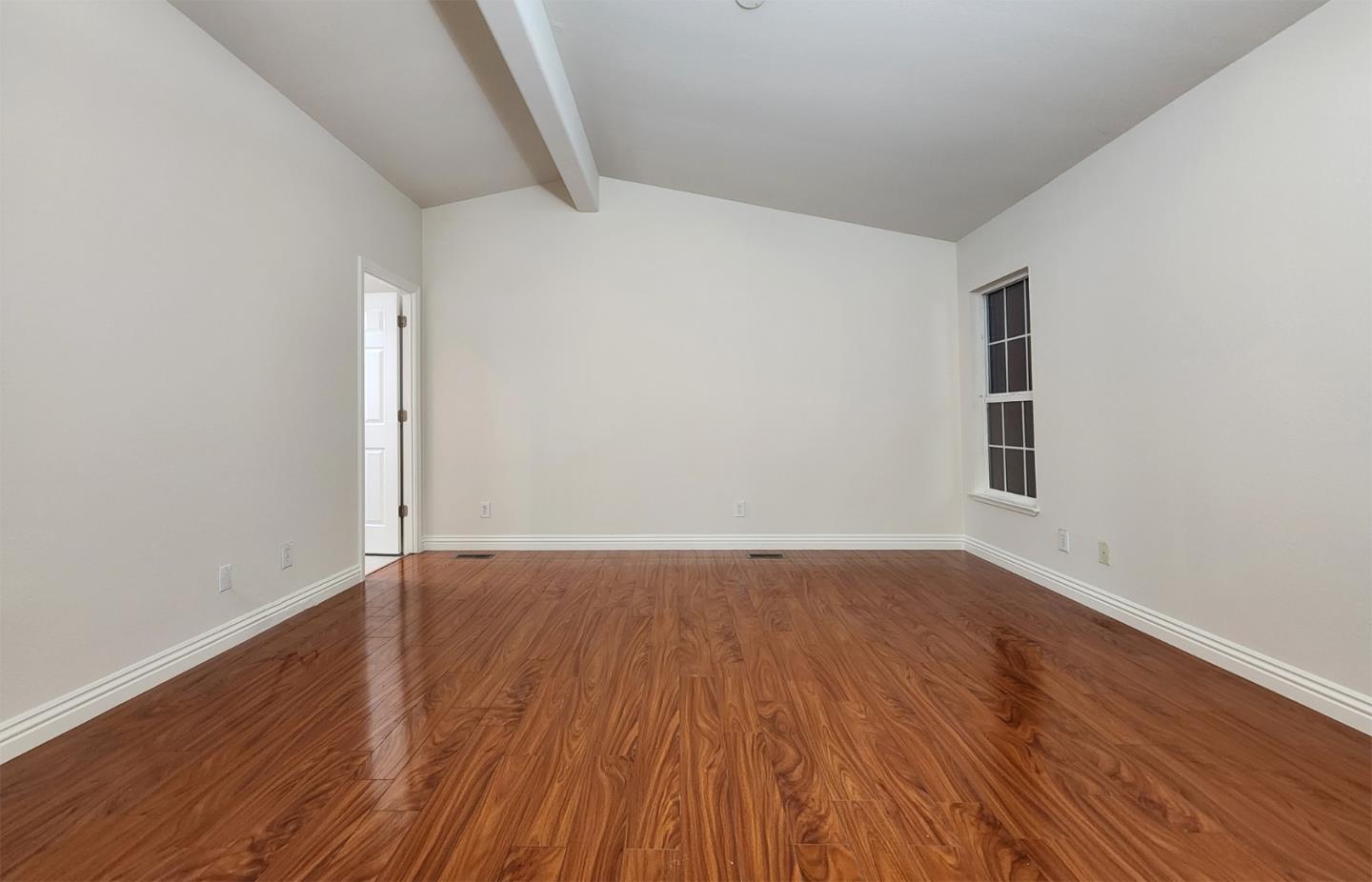 555 Umbarger Road, Unit 134 San Jose, CA 95111 - Photo 7 of 11 an empty room with wooden floor and windows