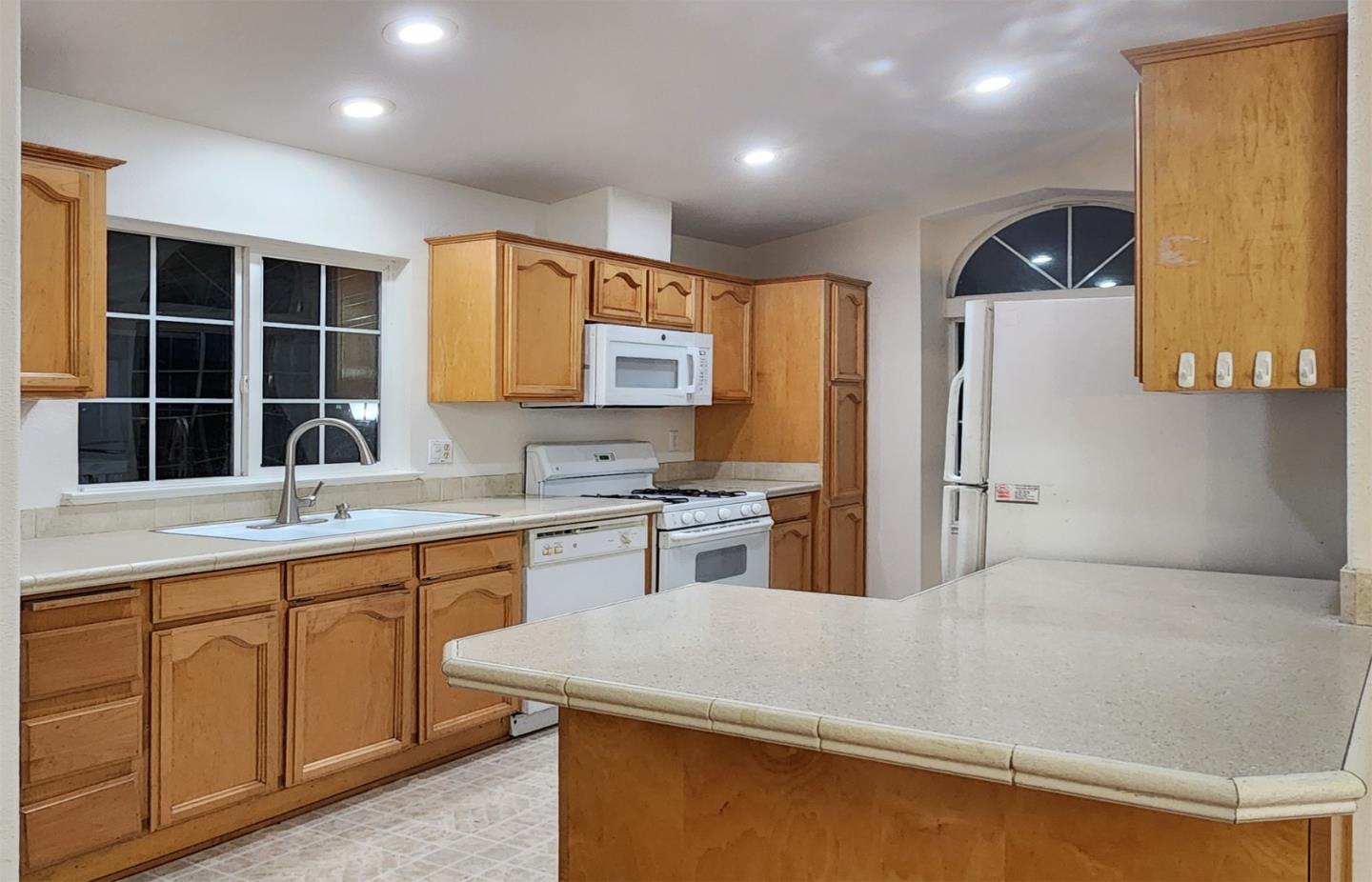555 Umbarger Road, Unit 134 San Jose, CA 95111 - Photo 8 of 11 a kitchen with stainless steel appliances granite countertop a sink dishwasher stove and refrigerator