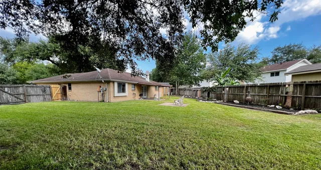 a white house that has a tree in it