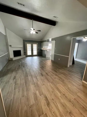 wooden floor in an empty room with a window
