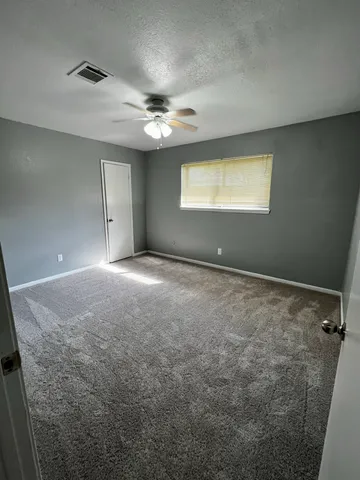 a view of an empty room with a window