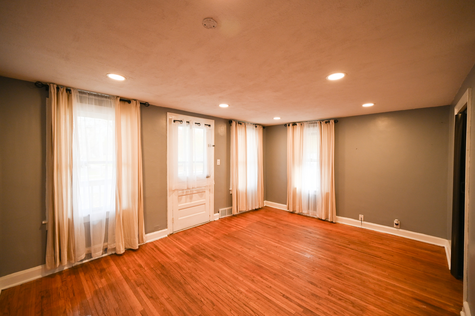 219 South 7th Street DeKalb, IL 60115 - Photo 13 of 30 a view of an empty room with wooden floor