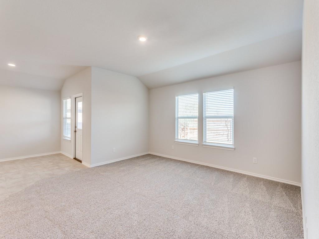 548 Bronze Circle West Springtown, TX 76082 - Photo 4 of 11 Neutral tone wall paint, recessed ceiling lighting, light-colored carpeting, multiple windows with blinds, and an exterior door with louvered blinds