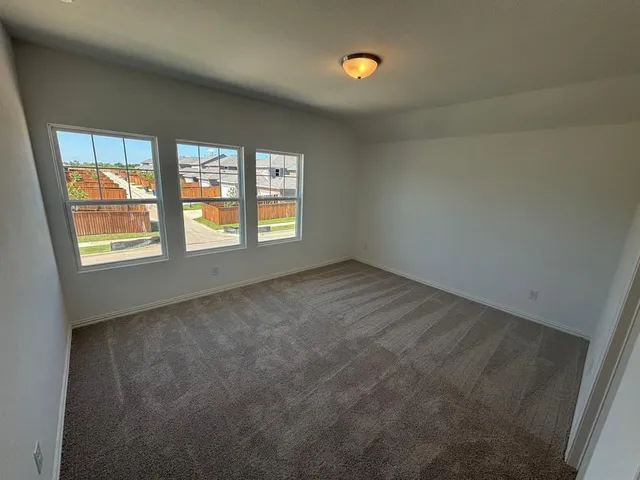 a large kitchen with granite countertop a large counter top stainless steel appliances and wooden floor