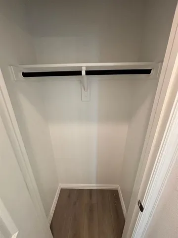 an empty room with windows and entrance