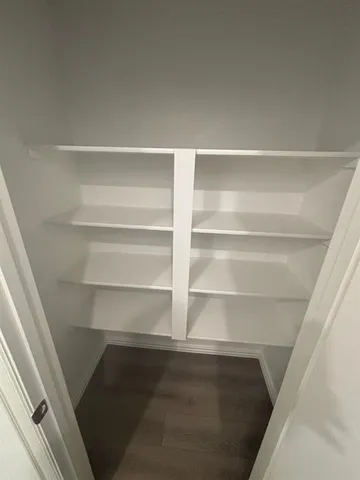 a view of walk in closet with empty racks