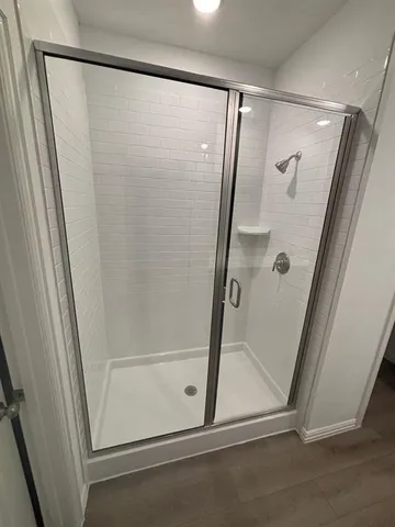 a bathroom with a glass shower door