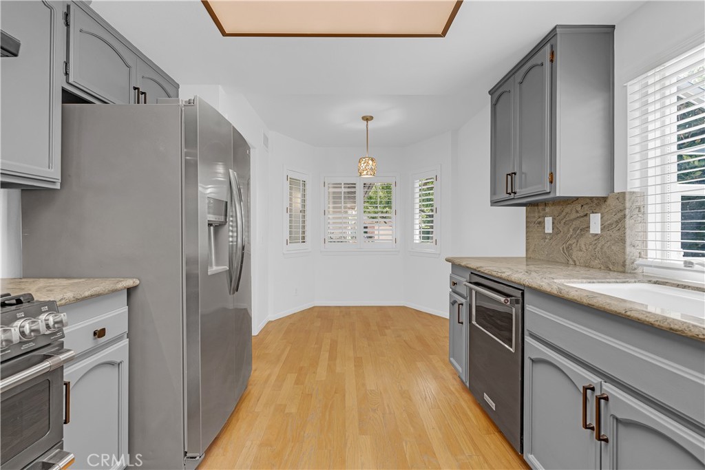 19451 Eagle Ridge Lane Porter Ranch, CA 91326 - Photo 24 of 59 a kitchen with stainless steel appliances granite countertop a sink stove and refrigerator