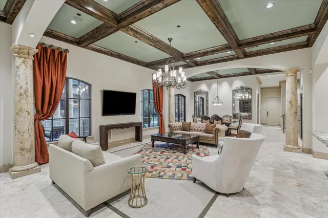 a living room with furniture and a chandelier