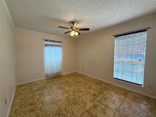 a bedroom with a bed couch and a window
