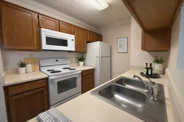 a kitchen with a sink stove and refrigerator