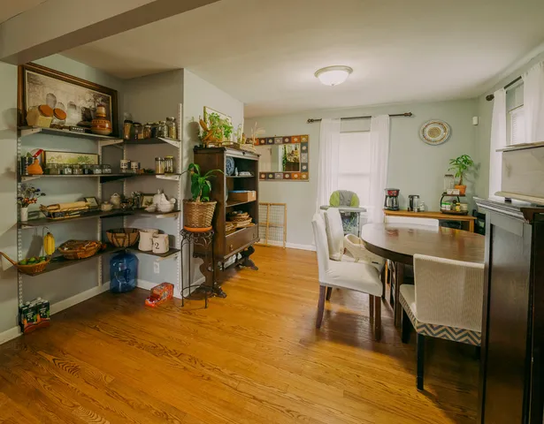 a view of a dining room with furniture and wooden floor