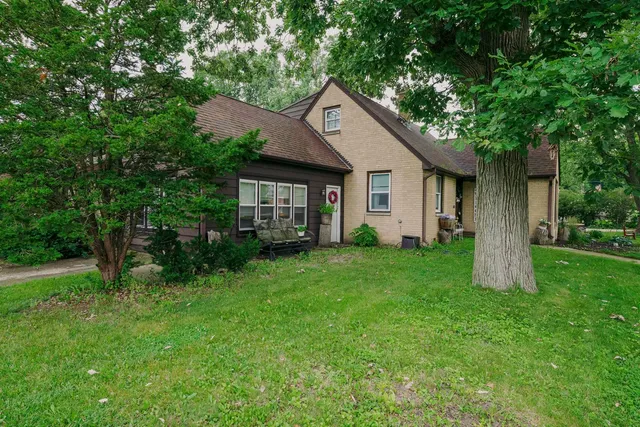a front view of house with yard and green space