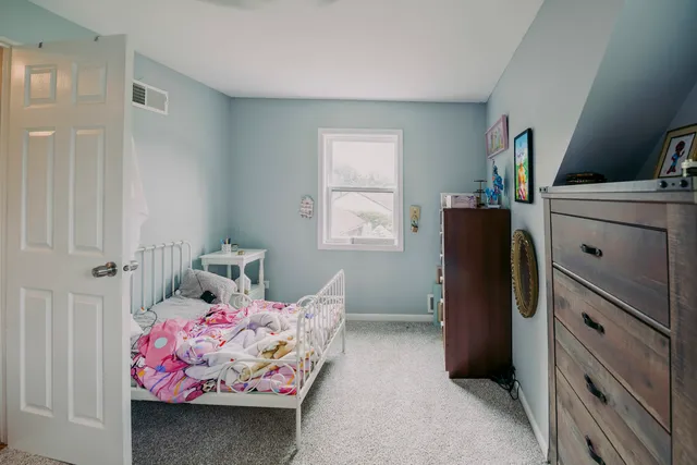 a bedroom with bed and window