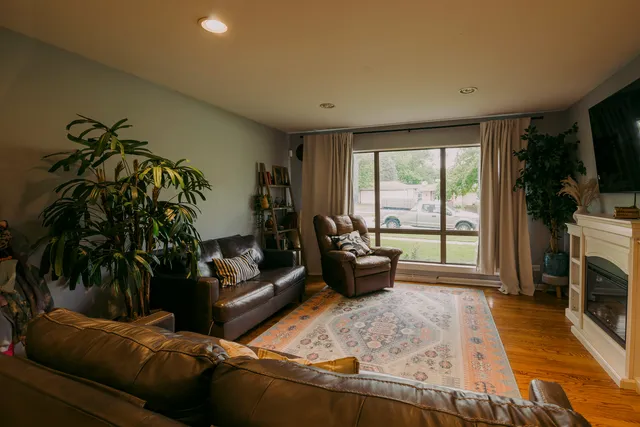 a living room with furniture large window and a fireplace