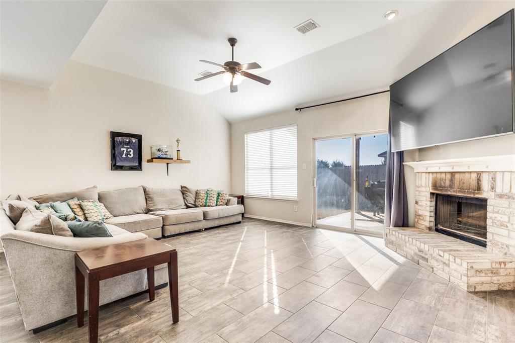 301 Turquoise Drive Fort Worth, TX 76131 - Photo 15 of 33 a living room with furniture and a fireplace
