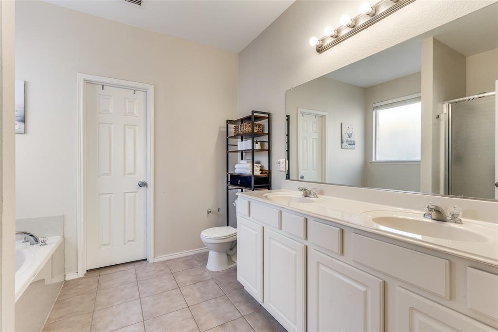 301 Turquoise Drive Fort Worth, TX 76131 - Photo 23 of 33 a bathroom with a sink a toilet and shower