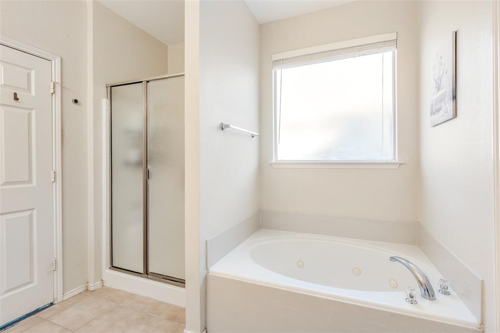 301 Turquoise Drive Fort Worth, TX 76131 - Photo 24 of 33 a white bath tub sitting next to a small window
