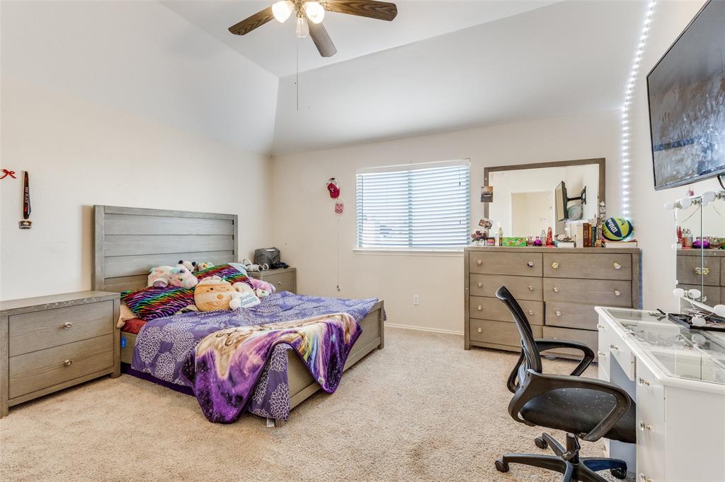 301 Turquoise Drive Fort Worth, TX 76131 - Photo 28 of 33 a bedroom with a bed a chair and a chandelier