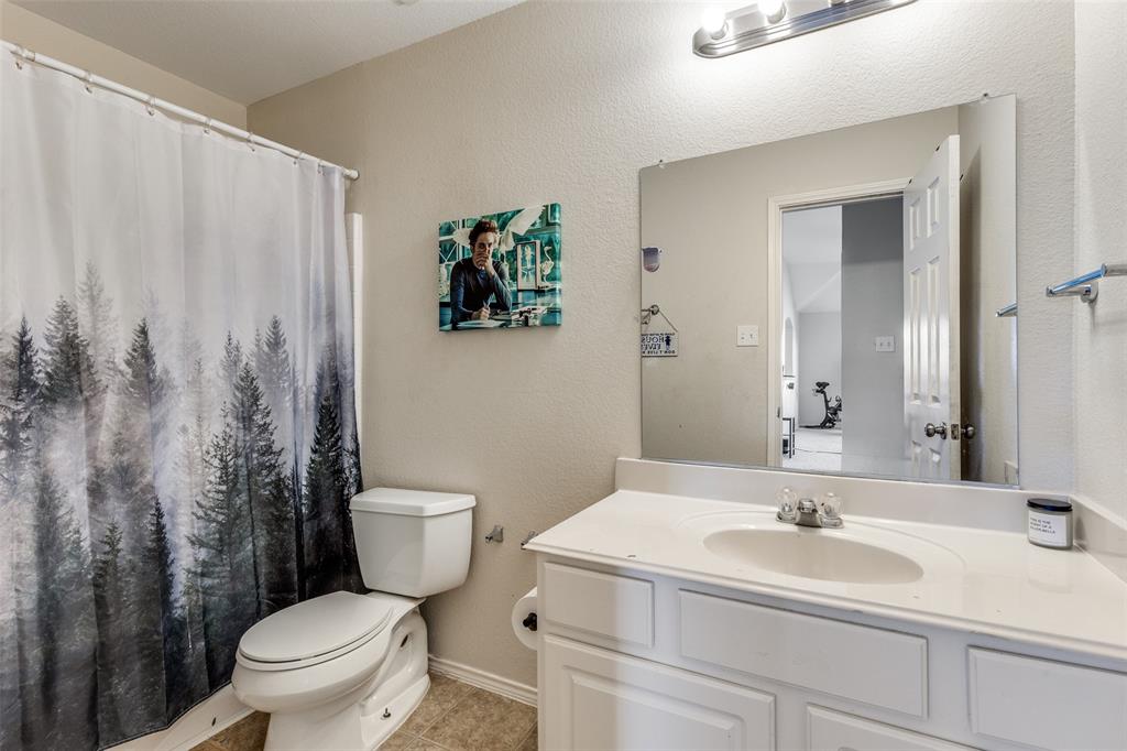 301 Turquoise Drive Fort Worth, TX 76131 - Photo 29 of 33 a bathroom with a toilet sink and mirror