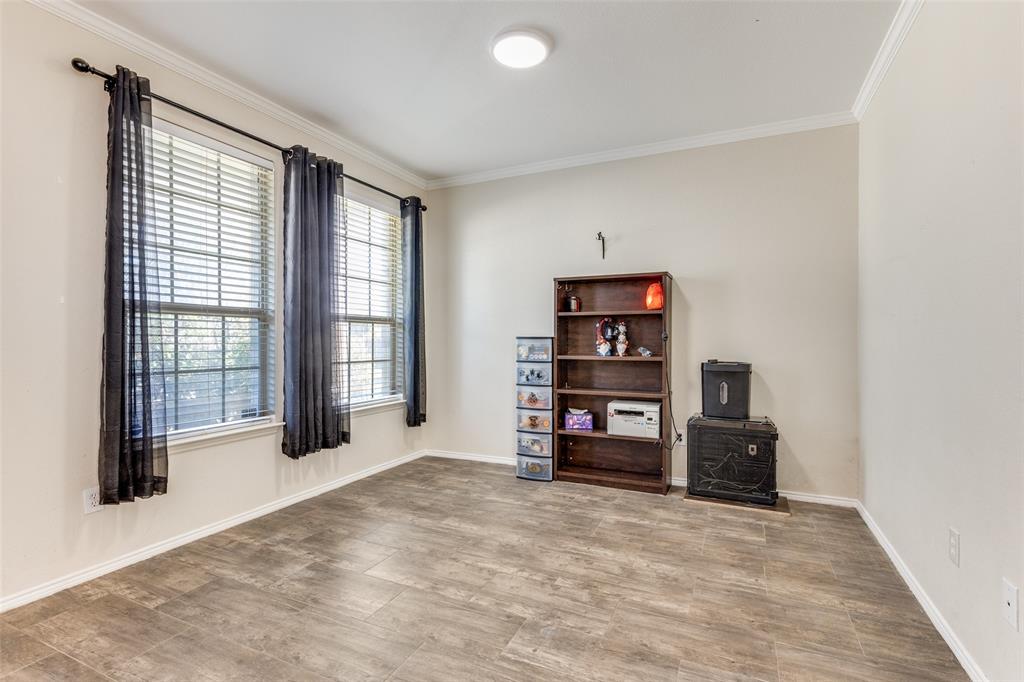 301 Turquoise Drive Fort Worth, TX 76131 - Photo 31 of 33 an empty room with bookshelf and a large window
