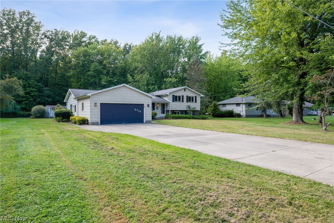 2715 Douglas Road Ashtabula, OH 44004 - Photo 3 of 34 Ranch-style house featuring garage and a front lawn