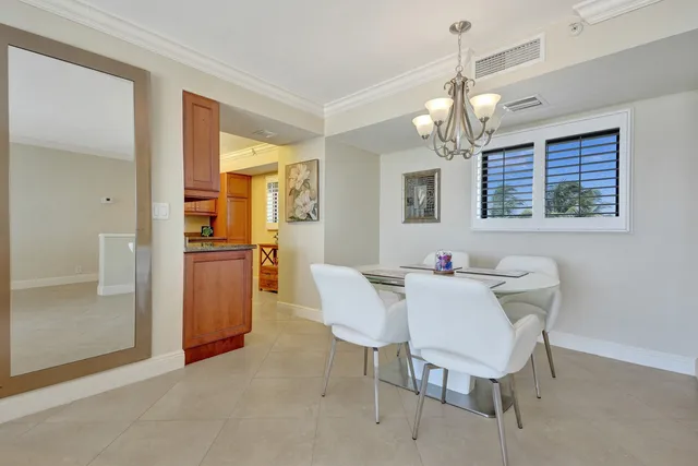 a bedroom with a bed and a dresser next to a window