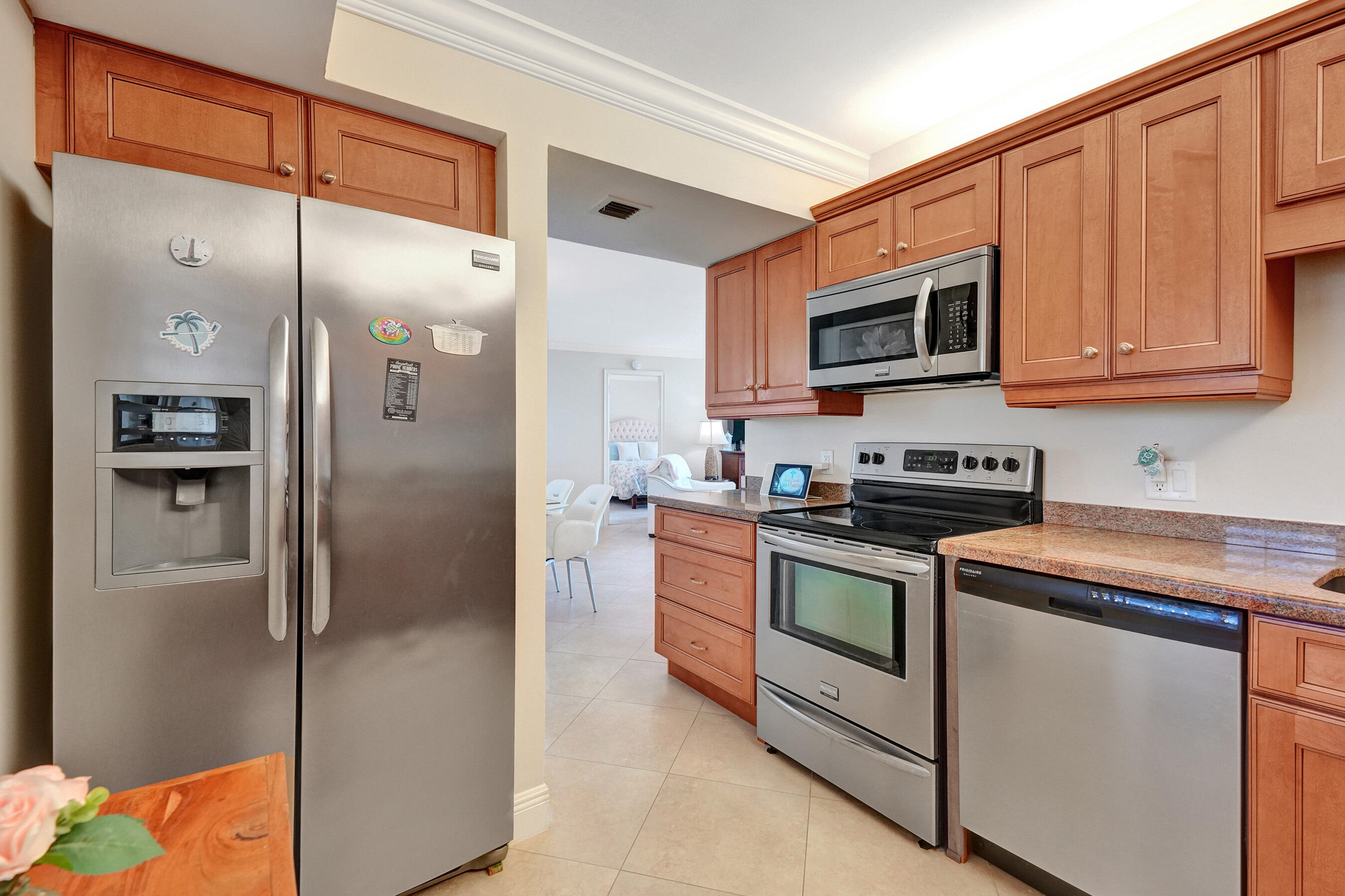 400 Ocean Trail Way, Unit 308 Jupiter, FL 33477 - Photo 23 of 65 a kitchen with stainless steel appliances granite countertop a refrigerator and a stove top oven
