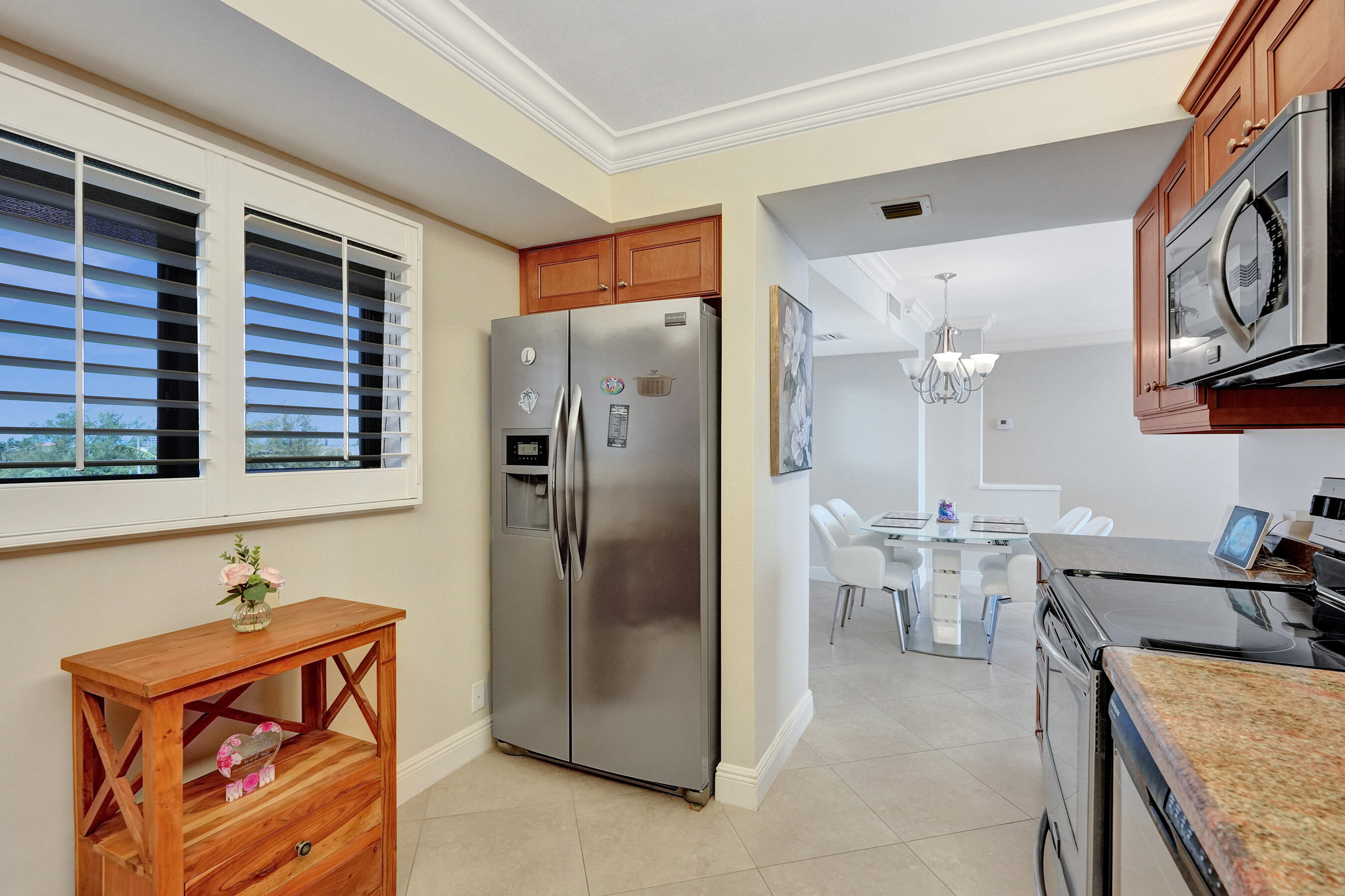 400 Ocean Trail Way, Unit 308 Jupiter, FL 33477 - Photo 24 of 65 a kitchen with stainless steel appliances granite countertop a refrigerator and a stove top oven