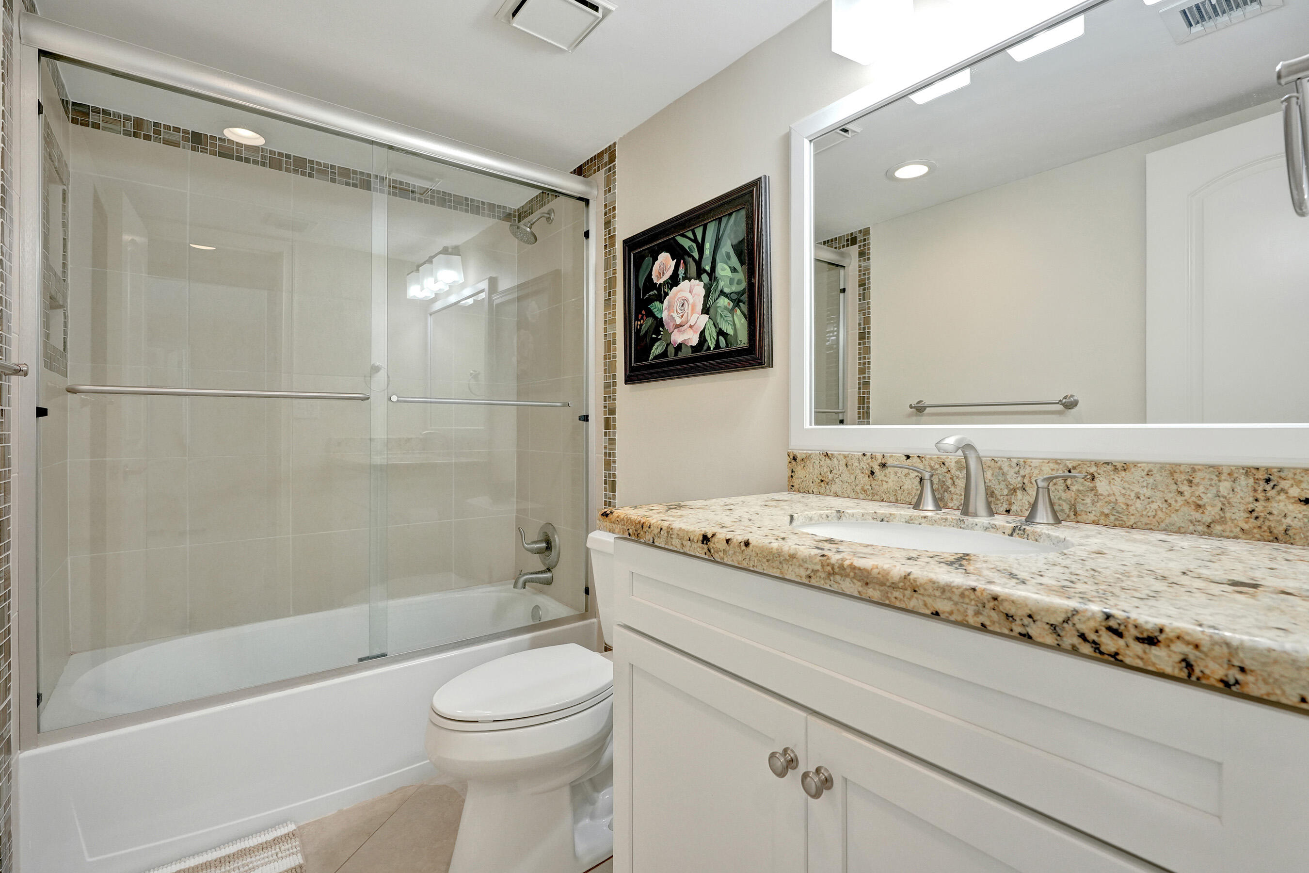 400 Ocean Trail Way, Unit 308 Jupiter, FL 33477 - Photo 40 of 65 a bathroom with a granite countertop sink toilet and shower