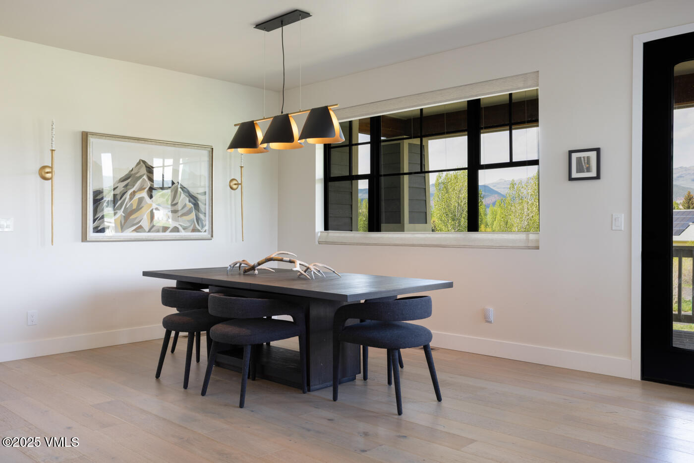 207 Aidan Road Eagle, CO 81631 - Photo 17 of 51 a view of a dining room with furniture window and wooden floor